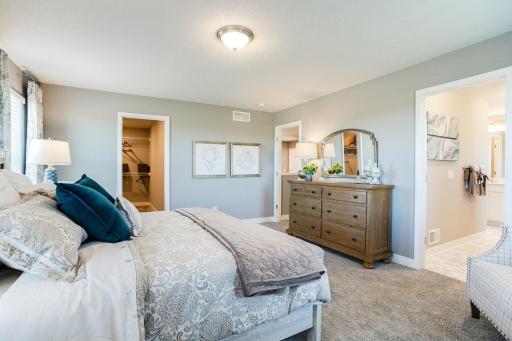 An oasis on it's own, the home's primary suite is awesome and loaded - including immediate access to a MASSIVE walk-in closet as well as a private bath that is equally stocked with features. Photo of model home. Selections will differ.