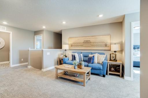Atop the staircase resides this game room (or loft), which can serve as that perfect place for a second family space and is just steps from each of the home's four second story bedrooms. Photo of model home. Selections will differ.