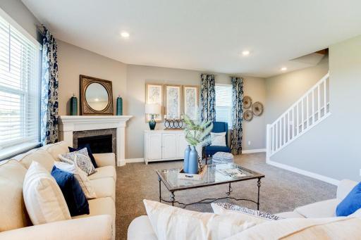 The homes main level family space is also nicely appointed with space -and will feature a corner gas fireplace to help ease the reality of those long winter evenings at home! Photo of model home. Selections and options show may vary.