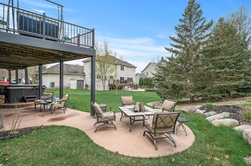 The patio sprawls into the back yard, expanding this outdoor oasis!