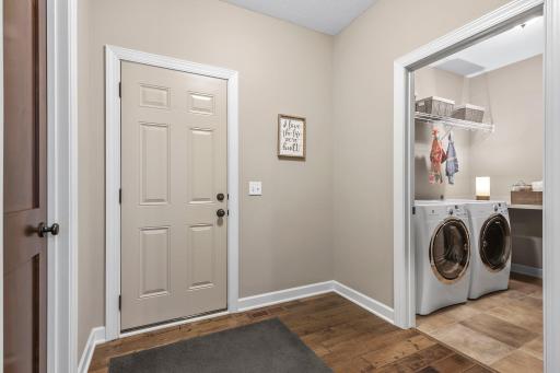 Convenience meets luxury in the adjoining mudroom, complete with a walk-in closet and access to the laundry room and garage.
