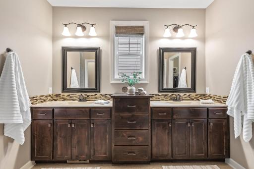 The ensuite bathroom exudes class and elegance with a double vanity, walk-in tile shower, and an expansive 11x8 walk-in closet.
