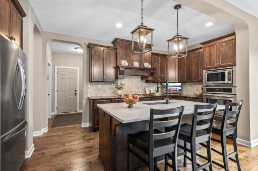 The gourmet kitchen is a chef's dream, highlighted by soft-close knotty alder cabinets and quartz countertops.