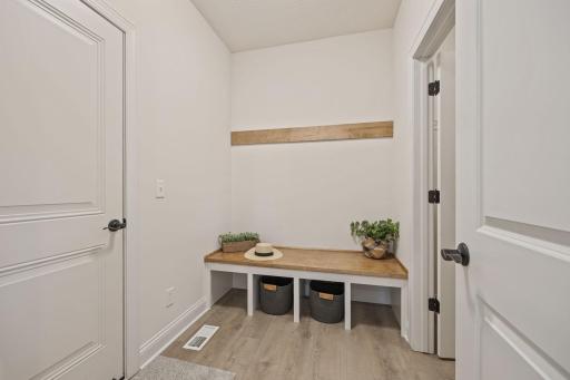Mudroom at garage entrance has large closet for additional seasonal wear!