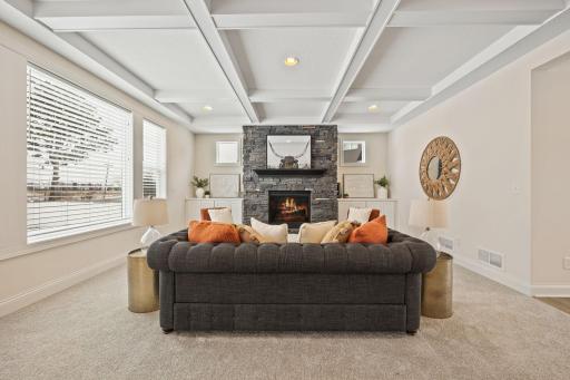 Coffered ceiling in living room adds a touch of elegance. Built-ins flank the gas fired stone fireplace.
