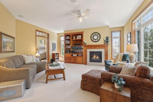 This main level family room is HUGE and oh so inviting. Extensive windows with transoms, custom cherry built-in and cozy gas fireplace.