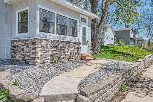 The tasteful landscaping complements a low-maintenance stucco exterior, accented by charming stone details!