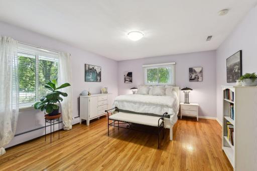 Spacious primary bedroom with large walk-in closet & custom shelving