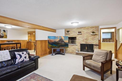 Lower level family space features a wood burning stove