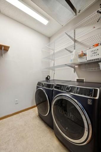 Main floor laundry space with extra wire shelving for storage