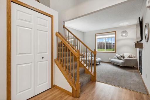 Spacious entry with soaring vaulted ceilings, laminate wood flooring, fresh paint, updated lighting, and natural light streaming through your windows!