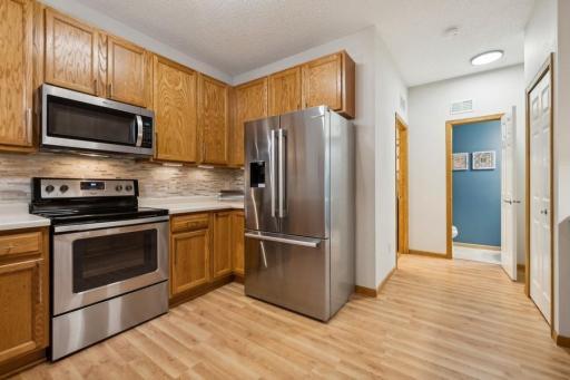 Another kitchen view.... just down the hall is the laundry room and convenient 1/2 bath, along with garage access! Carrying in groceries is a BREEZE!