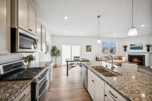 The heart of the home features a beautiful kitchen complete with stylish countertops, a sleek backsplash, and stainless steel appliances, making meal preparation a delight.