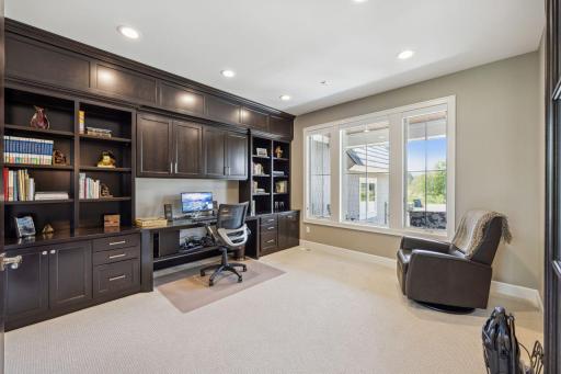 Main floor office has built in desk and cabinetry.