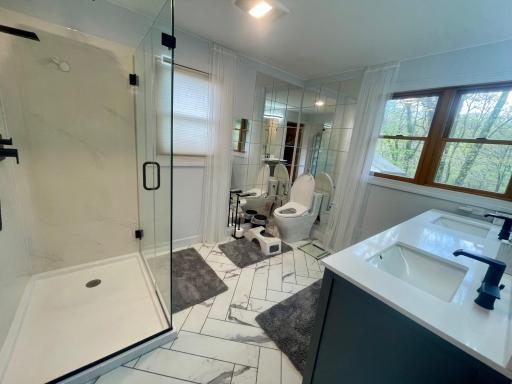 Beautifully remodeled master bath w/double vanity, glass shower and complete w/a Toto upgraded toilet!