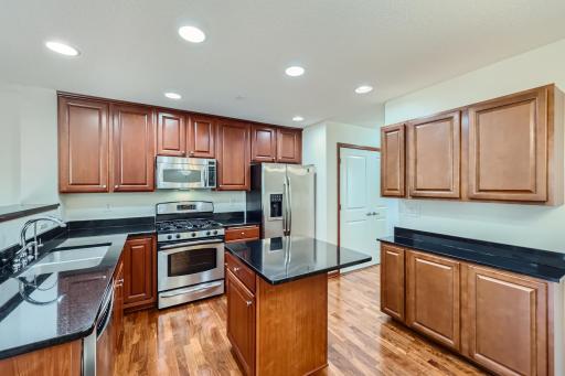 Beautiful kitchen with stainless steel appliances, granite counter tops, center island w/ granite countertop, serving buffet, hardwood floors and new reverse osmosis.