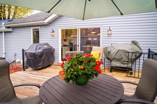 Step out of the kitchen patio doors to outdoor deck and fenced backyard.
