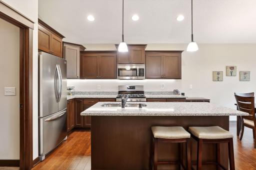 Gourmet kitchen with large center island, granite counter tops, and stainless steel appliances.