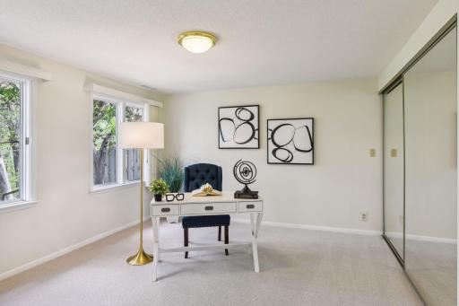 Excellent fourth bedroom space perfect for guests featuring full length mirror closet doors.