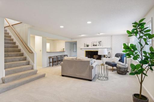 Large staircase leading to the lower level walk-out which has newly installed carpet. Enjoy family time and entertain with the wet-bar and game room.