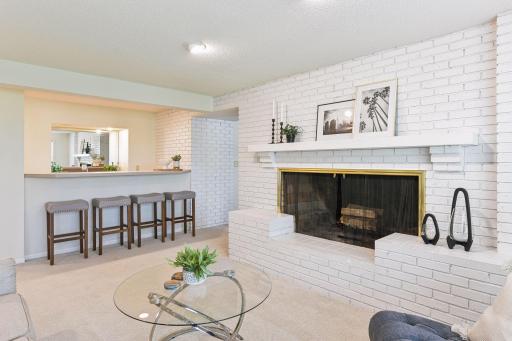 Entertain all your guests with a cozy fireplace and bar with ample seating.