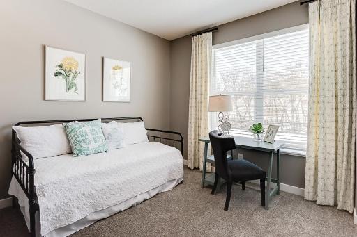 Tucked back off the mudroom, and away from the hustle and bustle of the main level living spaces, this bedroom resides adjacent to a 3/4 bath and serves as the perfect guest room or your home office! (Photo of model, colors may vary)