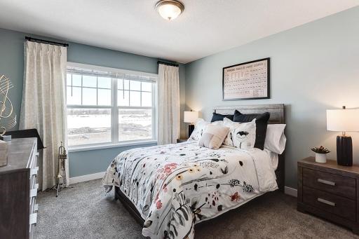 Each of the home's spacious secondary bedrooms feature well thought out window locations, plus each have a walk-in closet of their own!! (Photo of model, colors may vary)