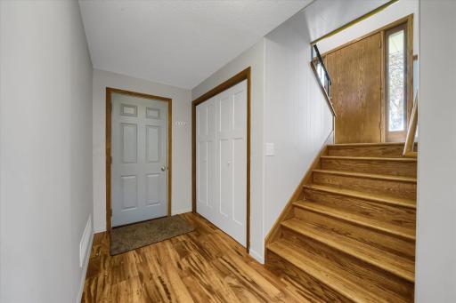 Door to garage, large closet at the bottom of the stairs, and front door.
