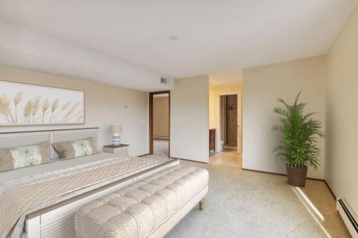 Primary bedroom is spacious and filled with natural light. Virtually Staged