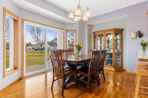 The dining room features hardwood floors and is conveniently located between the kitchen and living room. The patio door from the dining room offers a seamless transition to the inviting backyard.