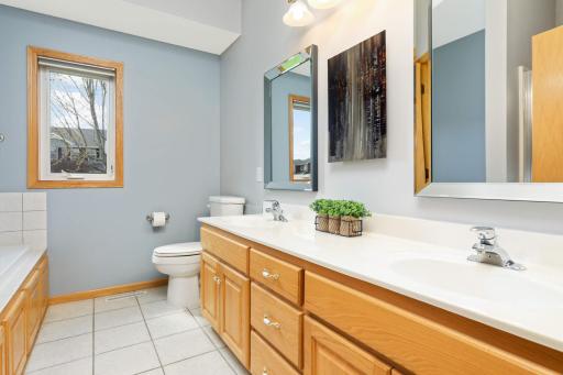 The main floor bathroom features dual sinks and an abundance of countertop space, ideal for morning routines. The main floor also features a 2nd bathroom.