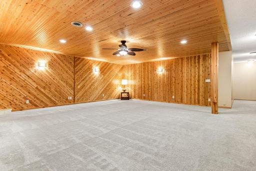 As you enter the lower level you'll find a large storage/mechanical room off to one side of the staircase. The other side has a lighted sports memorabilia area before you enter the family room. You'll love the cool knotty pine vibe too!