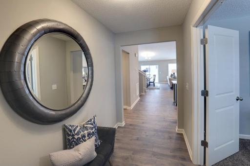 A look into the home from the entrance off the main door. Doors to the right lead to a study / flex room.(Model home photo, actual home will vary in colors and materials.)