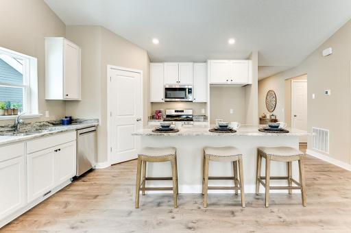 Walk-in pantry and ample cabinet space. *Staged Model photo, actual selections and options may vary.