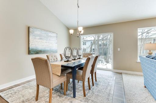 The dining room with a sliding glass door for easy access to your backyard.(Model home photo, actual home will vary in colors and materials.)