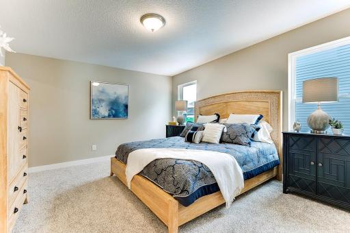 The primary bedroom boasts size and peacefulness with is large closet and primary bathroom. (Model home photo, actual home will vary in colors and materials.)