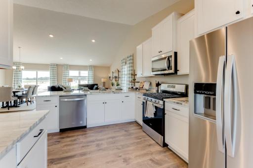 Stunning in every direction, the kitchen is also remarkably functional - leaving plenty of space for the family chef to maneuver and prepare that next meal. Photo is of model - colors may vary.