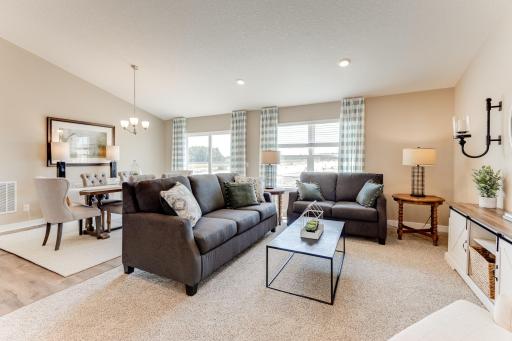 The main level family room will hold most any furniture arrangement, and like the rest of the home, soaks itself in natural light! Photo is of model - colors may vary.