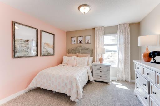 In addition to the primary bedroom, the home's upper level also includes these two additional bedrooms, and another full bathroom just adjacent to each! Photo is of model - colors may vary.