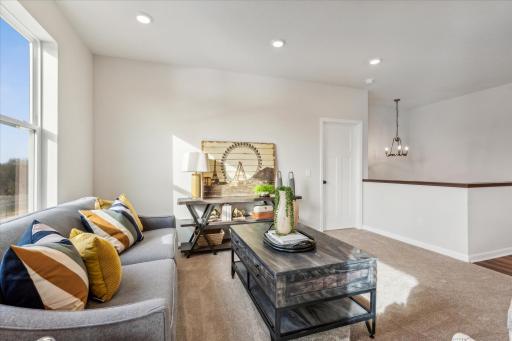 Main level living at it's finest- the open concept family room leads to the primary suite.