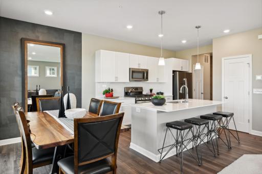 Open concept, the home's kitchen space is highly desirable and features a large kitchen island serving as the perfect centerpiece for cooking and entertaining! *Photos of model home; colors and finishes will vary.