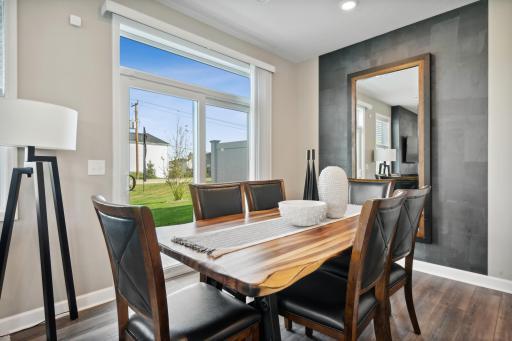 Soaked in natural sunlight, the homes eat-in dining room has ample room for a dining table located in the heart of the home. *Photos of model home; colors and finishes will vary.