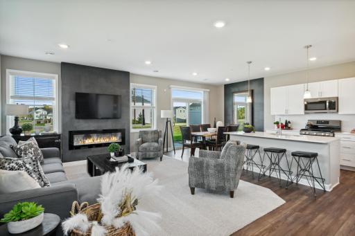 The main level is amplified by the warm natural light from the large windows and adjacent patio. *Photos of model home; colors and finishes will vary.