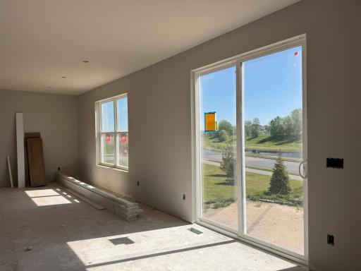 The main level showcases an 8' patio door for additional natural light and will have light-wash LVP flooring running throughout.