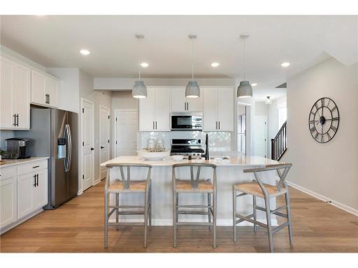 Wide open modern floorplan creates a memorable and striking home from any angle! Photo of model home.