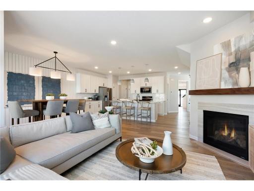 Come over to the living room perfect for any occasion! Both spacious and luxurious, this living room is perfect for any occasion! Photo of model home.