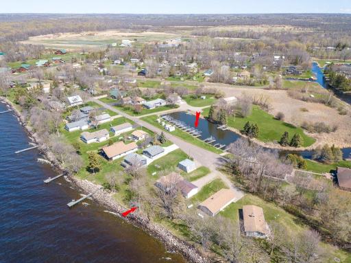 Aerial view shows the lovely lakeshore frontage and the large harbor behind where you have your own private dock/slip!