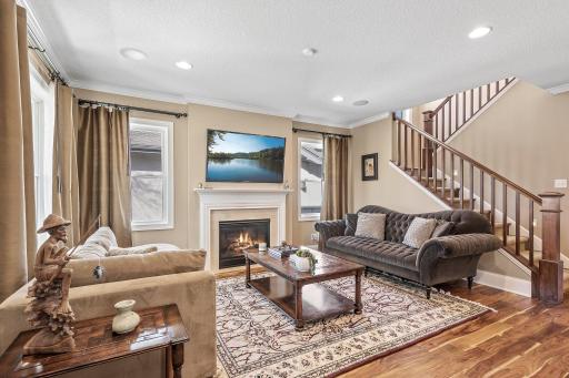 As you step into this home, you're greeted by the elegance of 9-foot ceilings, natural woodwork, and hand-scraped Asian walnut floors, creating a warm and inviting ambiance.