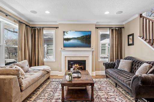 The living room is a cozy retreat featuring a gas fireplace and expansive windows that fill the space with natural light.