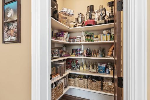 A walk-in pantry provides ample storage space for kitchen essentials.